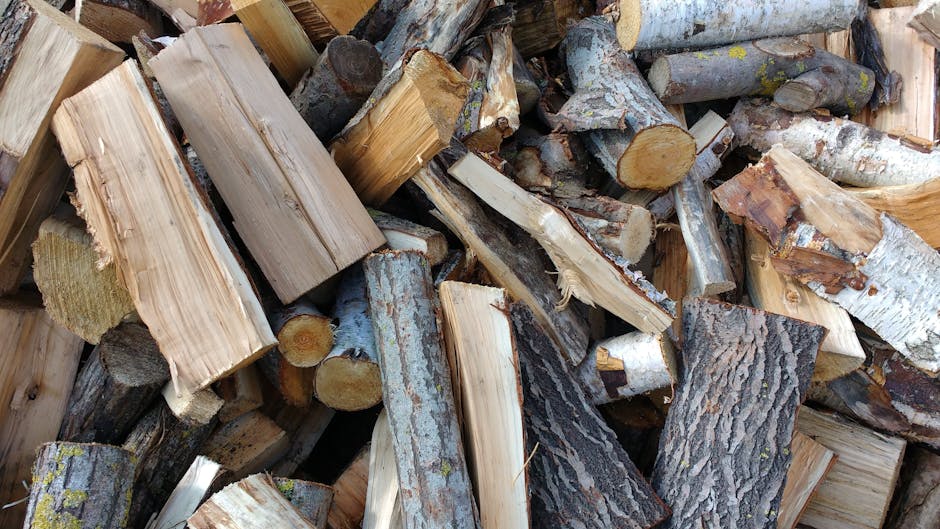 Close-up view of chopped firewood logs stacked outdoors, perfect for heating or crafting.