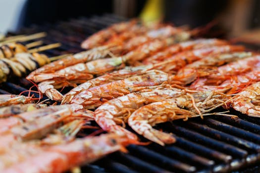 Close-up of delicious grilled shrimps and seafood on a hot barbecue grill, perfect for summer dining.